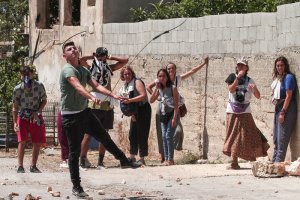 Filistinli gençler sapanları ile silahlı işgalcilere geçit vermiyor